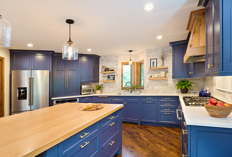 Kitchen cabinets that have been painted a relaxing blue by a team of interior painters.