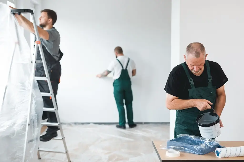 A professional interior painting crew gets ready to paint the inside of a room.