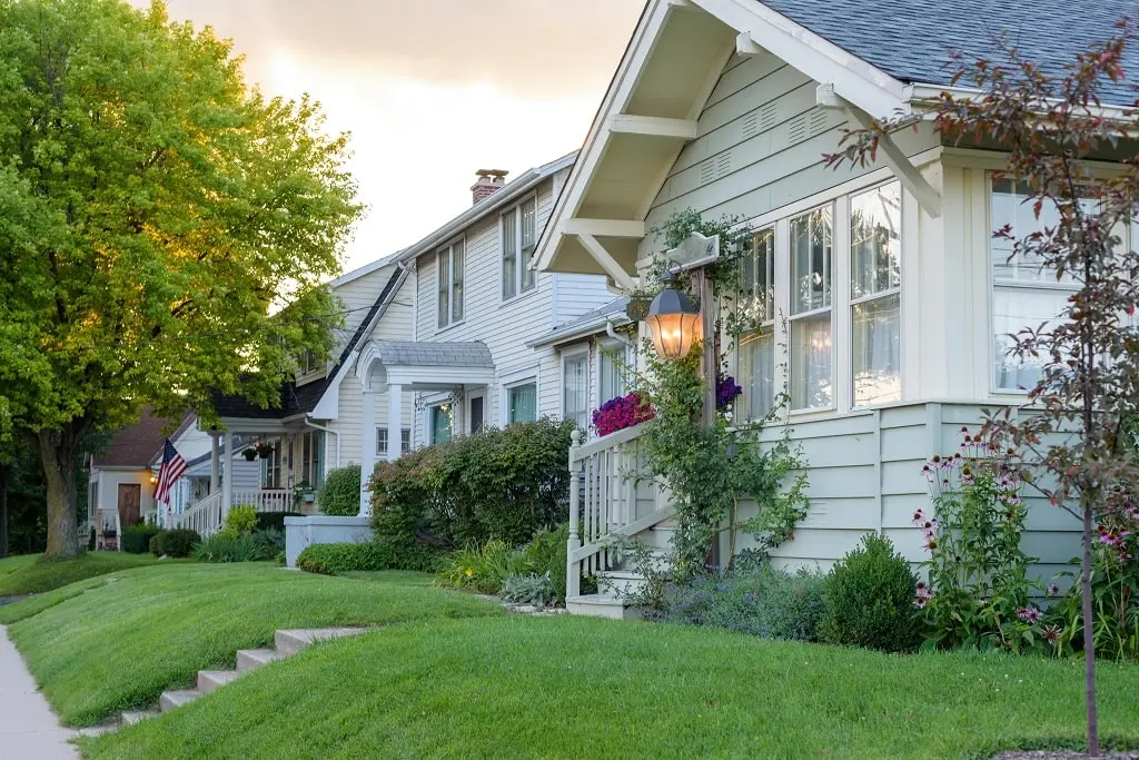 A row of charming homes on a small town road at sunset.