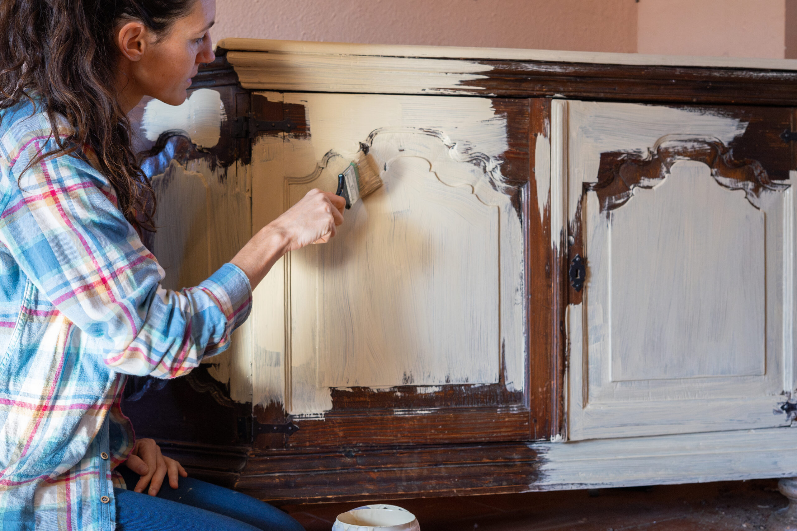 woman restoring a cabinet
