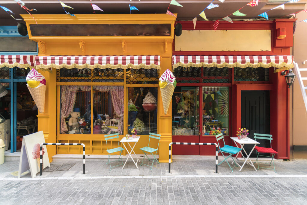 Inviting ice cream shopfront with colorful outdoor seating ready for customers