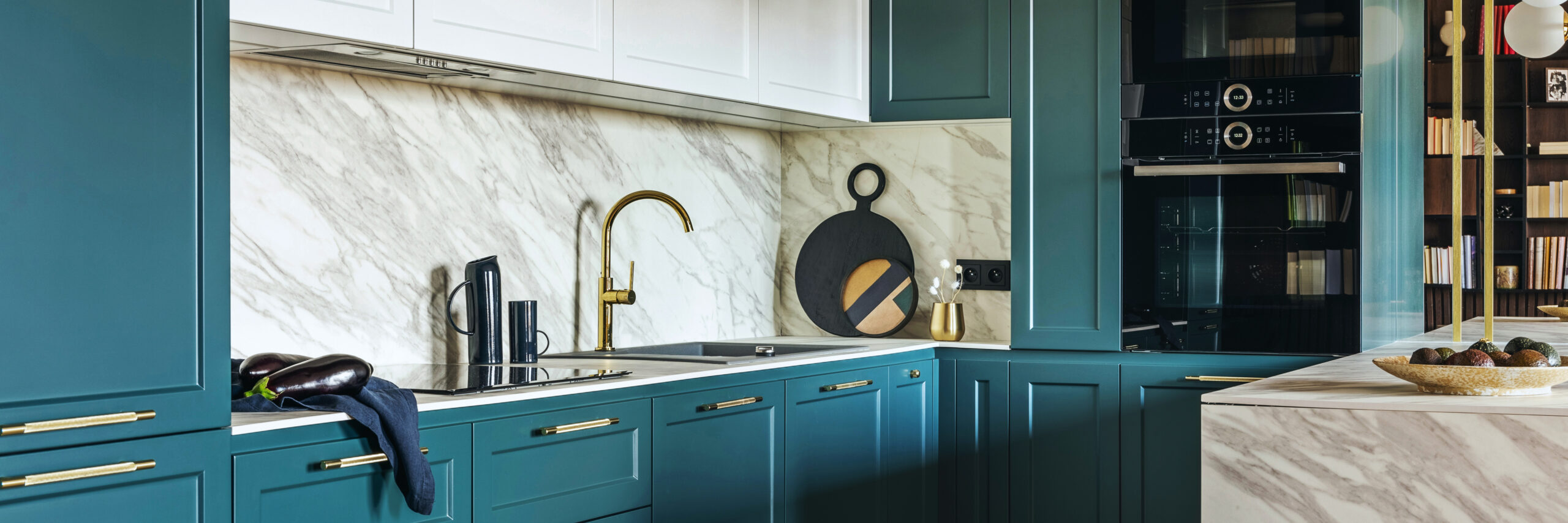Luxury modern and vintage turquoise and white kitchen. Marble kitchen island with white owal chandelier . Gold tap on marble table top. Template.